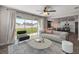 Open-concept living room with modern furnishings, neutral decor, and view of the eat-in kitchen at 7695 Sw 64Th Street Rd, Ocala, FL 34474
