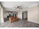 Open-concept living space with tile flooring, neutral walls, and kitchen view at 7695 Sw 64Th Street Rd, Ocala, FL 34474