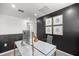 Home office with a white desk, dark accent wall, and modern artwork at 7695 Sw 64Th Street Rd, Ocala, FL 34474