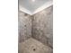 Modern shower featuring gray tile walls, flooring and a shower head at 7695 Sw 64Th Street Rd, Ocala, FL 34474
