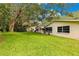 Backyard featuring mature trees, lush lawn, and view of homes with screened-in porches at 8850 Sw 97Th St # C, Ocala, FL 34481