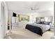 Bedroom features a ceiling fan, closet storage, window and comfortable bed at 8850 Sw 97Th St # C, Ocala, FL 34481