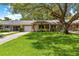 Inviting one-story home with a well-manicured lawn and mature oak tree at 8850 Sw 97Th St # C, Ocala, FL 34481