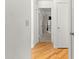 Hallway showcasing wood floors with a view of bedrooms and closet space at 8850 Sw 97Th St # C, Ocala, FL 34481