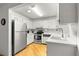 Bright kitchen with stainless steel appliances and white cabinets and wood-look flooring at 8850 Sw 97Th St # C, Ocala, FL 34481