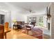 Bright living room with a fireplace, wood floors and cozy leather furniture at 8850 Sw 97Th St # C, Ocala, FL 34481