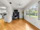 Living room features hardwood floors, a ceiling fan, and an adjacent eat-in kitchen at 8850 Sw 97Th St # C, Ocala, FL 34481