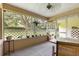 Enclosed porch with neutral tones, lattice accents, and a view of the outside greenery at 8850 Sw 97Th St # C, Ocala, FL 34481