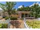 Backyard with well-manicured landscaping, sunroom, and white picket fence at 8881 Sw 94Th St # E, Ocala, FL 34481