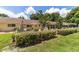 Well-manicured backyard with a white picket fence and covered patio area at 8881 Sw 94Th St # E, Ocala, FL 34481