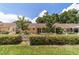 Well-manicured backyard with a white picket fence and covered patio area at 8881 Sw 94Th St # E, Ocala, FL 34481