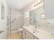 Bright bathroom featuring a walk-in shower, a modern vanity, and tile floors at 8881 Sw 94Th St # E, Ocala, FL 34481