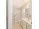 Bathroom featuring glass shower doors, a large mirror, and tile flooring at 8881 Sw 94Th St # E, Ocala, FL 34481