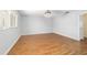 Bright bedroom with wood-look floors and a modern chandelier at 8881 Sw 94Th St # E, Ocala, FL 34481