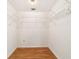 Walk-in closet featuring wood-look floors and ample shelving at 8881 Sw 94Th St # E, Ocala, FL 34481