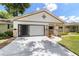Charming single-story home with a cozy front porch, garage, and well-manicured landscaping at 8881 Sw 94Th St # E, Ocala, FL 34481
