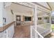 Inviting front porch featuring decorative railings, stone accents, and a ceiling fan at 8881 Sw 94Th St # E, Ocala, FL 34481