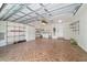 Spacious garage featuring tiled floors, shelving, washer/dryer, and utility sink at 8881 Sw 94Th St # E, Ocala, FL 34481
