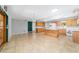 Bright kitchen features a center island, tile floors, wood cabinets and modern appliances at 8881 Sw 94Th St # E, Ocala, FL 34481