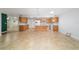 Bright kitchen features a center island, tile floors, wood cabinets and modern appliances at 8881 Sw 94Th St # E, Ocala, FL 34481
