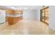 Bright kitchen features a center island, tile floors, wood cabinets and modern appliances at 8881 Sw 94Th St # E, Ocala, FL 34481