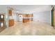 Bright kitchen features a center island, tile floors, wood cabinets and modern appliances at 8881 Sw 94Th St # E, Ocala, FL 34481