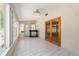 Bright sunroom with full windows, an antique bar, and french doors to another room at 8881 Sw 94Th St # E, Ocala, FL 34481