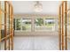 Bright sunroom featuring white wood look floors and glass windows for lots of natural light at 8881 Sw 94Th St # E, Ocala, FL 34481