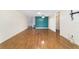 Spacious living room with hardwood floors, a feature wall, and neutral decor at 8881 Sw 94Th St # E, Ocala, FL 34481