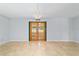 Open living room with neutral tile flooring, decorative lighting fixture, and glass french doors to lanai at 8881 Sw 94Th St # E, Ocala, FL 34481