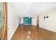 Bright living room featuring wood flooring, a modern light fixture and fresh teal paint at 8881 Sw 94Th St # E, Ocala, FL 34481