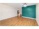 Spacious living room featuring hard wood floors, french doors, and a feature wall at 8881 Sw 94Th St # E, Ocala, FL 34481