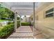 Charming patio with a pergola, tile flooring, and well-maintained landscaping at 8881 Sw 94Th St # E, Ocala, FL 34481