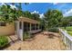 Exterior view of a sunroom with surrounding landscaping and white picket fence at 8881 Sw 94Th St # E, Ocala, FL 34481