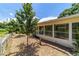 Exterior view of a bright sunroom with beautiful landscaping and a statue at 8881 Sw 94Th St # E, Ocala, FL 34481