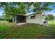 View of backyard, house, and screened in porch at 8973 Sw 104Th Pl, Ocala, FL 34481