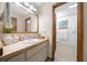 Bright bathroom featuring a vanity with decorative accents and access to the toilet at 8973 Sw 104Th Pl, Ocala, FL 34481