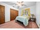 Bedroom featuring a queen-sized bed, ceiling fan, and closet at 8973 Sw 104Th Pl, Ocala, FL 34481