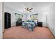 Spacious bedroom featuring carpet floors, a ceiling fan, and natural light from windows at 8973 Sw 104Th Pl, Ocala, FL 34481