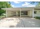 Attached carport featuring lattice work, access to the screen porch, and spacious layout at 8973 Sw 104Th Pl, Ocala, FL 34481