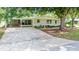 Well-maintained single story home featuring a driveway, carport, landscaping, and lawn at 8973 Sw 104Th Pl, Ocala, FL 34481