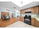 Open kitchen with wood cabinets and breakfast nook connected to the dining room at 8973 Sw 104Th Pl, Ocala, FL 34481