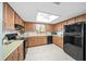 Functional kitchen featuring wood cabinets, black appliances, and ample counter space at 8973 Sw 104Th Pl, Ocala, FL 34481