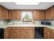 Cozy kitchen featuring wood cabinets, white countertops, and window view at 8973 Sw 104Th Pl, Ocala, FL 34481