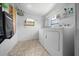 Bright laundry room featuring washer, dryer, and shelving for storage at 8973 Sw 104Th Pl, Ocala, FL 34481