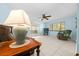Comfortable living room featuring tile floors, ceiling fan, and sliding glass doors at 8973 Sw 104Th Pl, Ocala, FL 34481