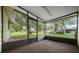 Screened-in porch offering views of the green backyard at 8973 Sw 104Th Pl, Ocala, FL 34481
