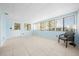 Sunroom with light blue walls, tiled floor, and large windows at 8973 Sw 104Th Pl, Ocala, FL 34481
