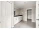 A bathroom is decorated with sleek dual sinks, neutral walls, and tiled floors leading to a walk-in closet at 9209 Sw 58Th Cir, Ocala, FL 34476