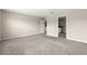 A bright, carpeted bedroom is shown with neutral paint, an en-suite bath, and a large window at 9209 Sw 58Th Cir, Ocala, FL 34476